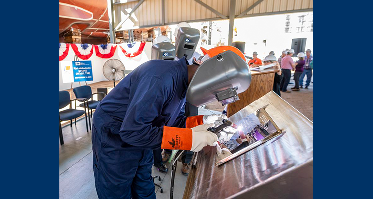 Laura Cavallo are welded onto a steel plate that will later be affixed to Coast Guard Cutter Stone